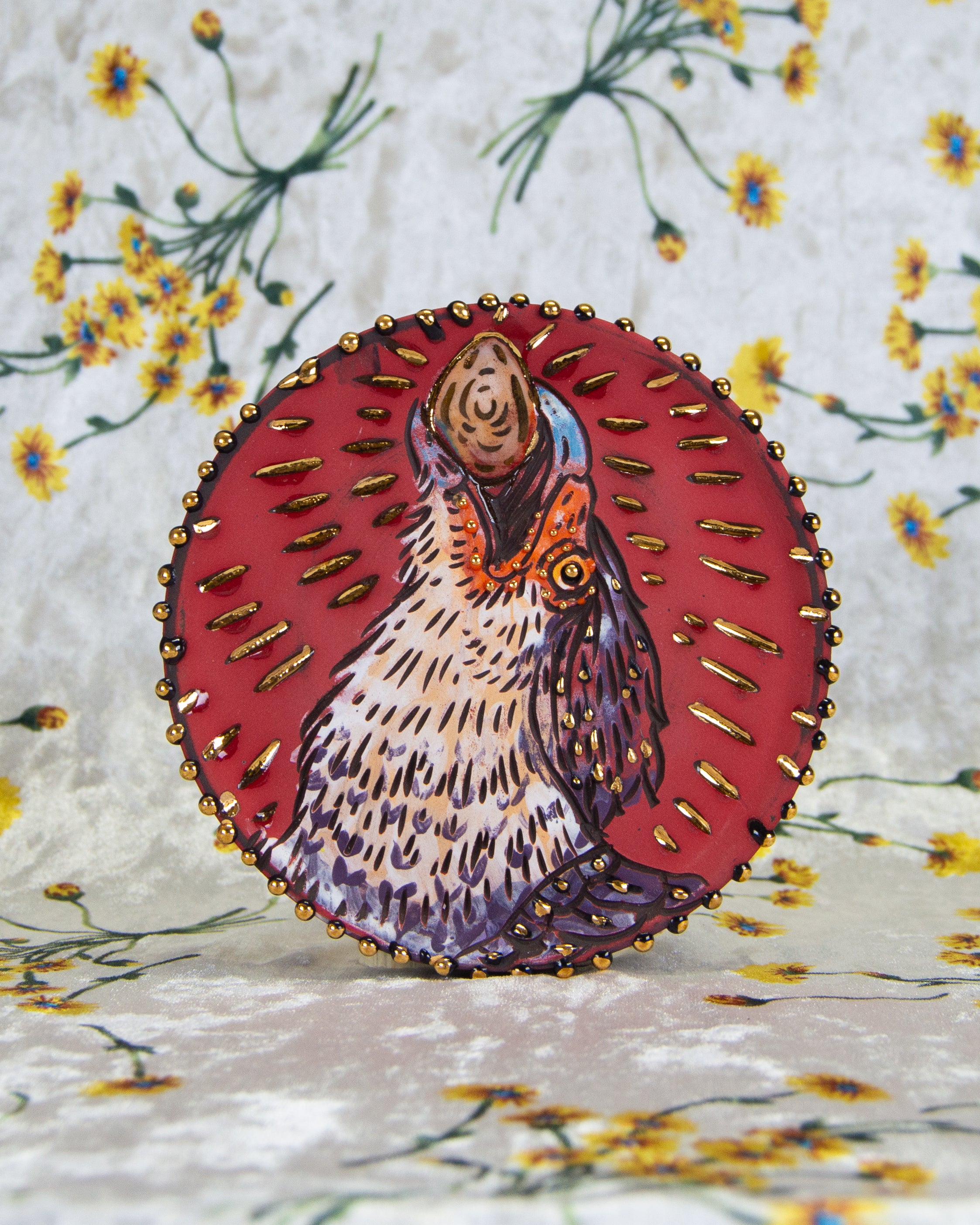 Handmade ceramic coaster with a colorful textured caracara mexican eagle design