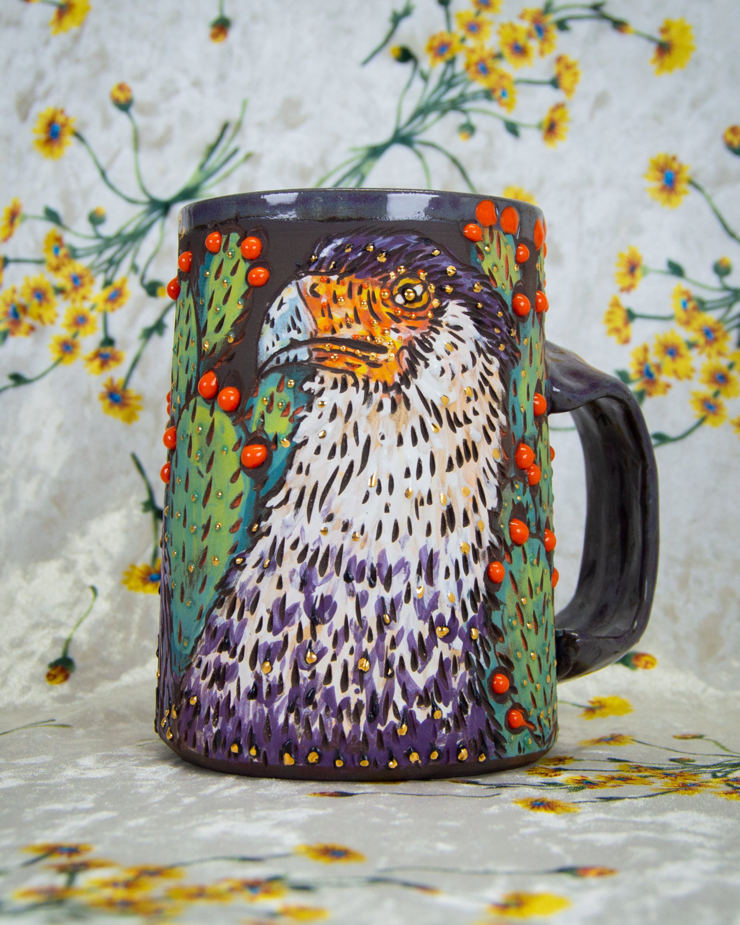 Handmade ceramic mug with a colorful caracara mexican eagle design and prickly pear cactus