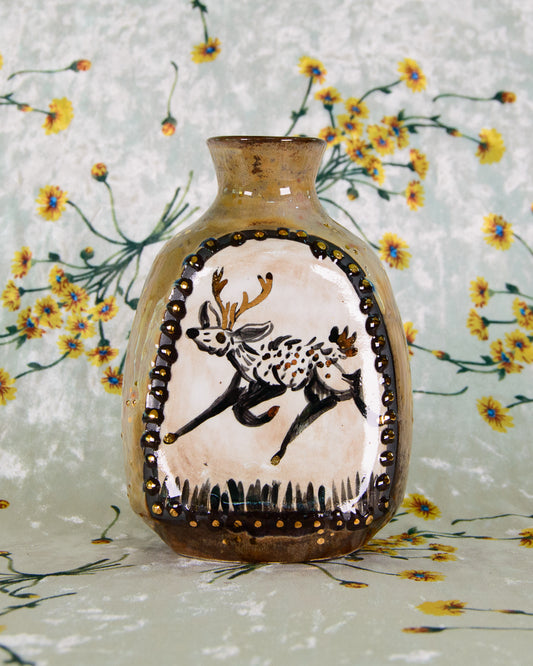 Decorative vase with a painted deer design on a floral background