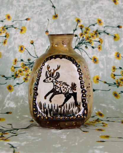 Decorative vase with a deer design on a floral background