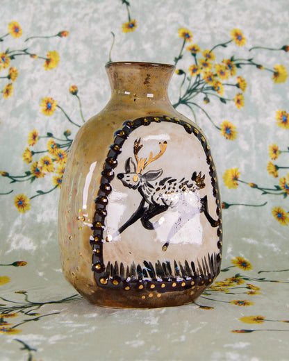 Decorative vase with a deer design on a floral background