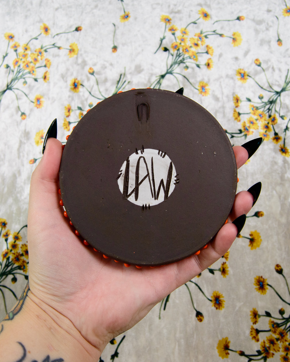 Ceramic coaster with LAW signature of Leigh Weinberg from Lawful Studios