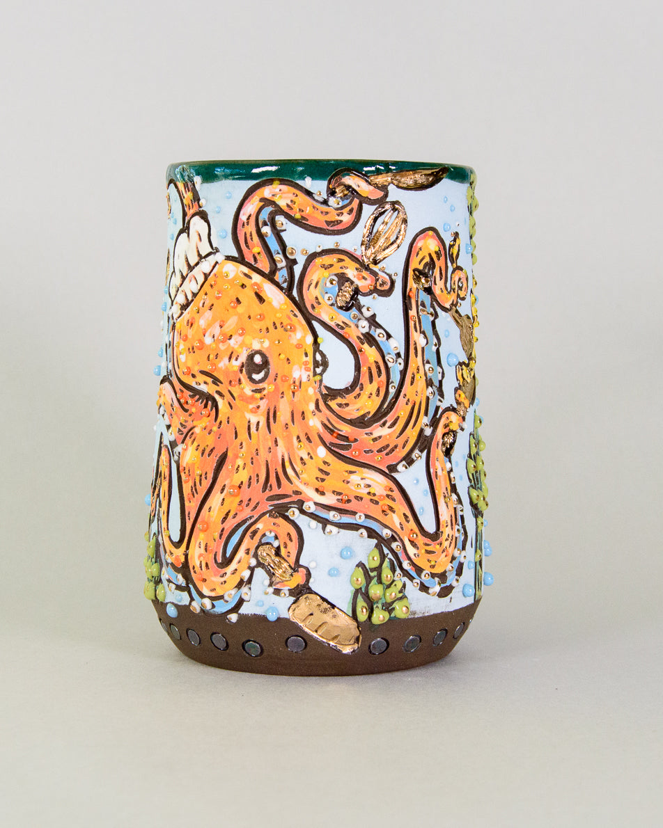 Handmade ceramic mug decorated with a chef octopus cooking with golden kitchen utensils and asparagus seaweed