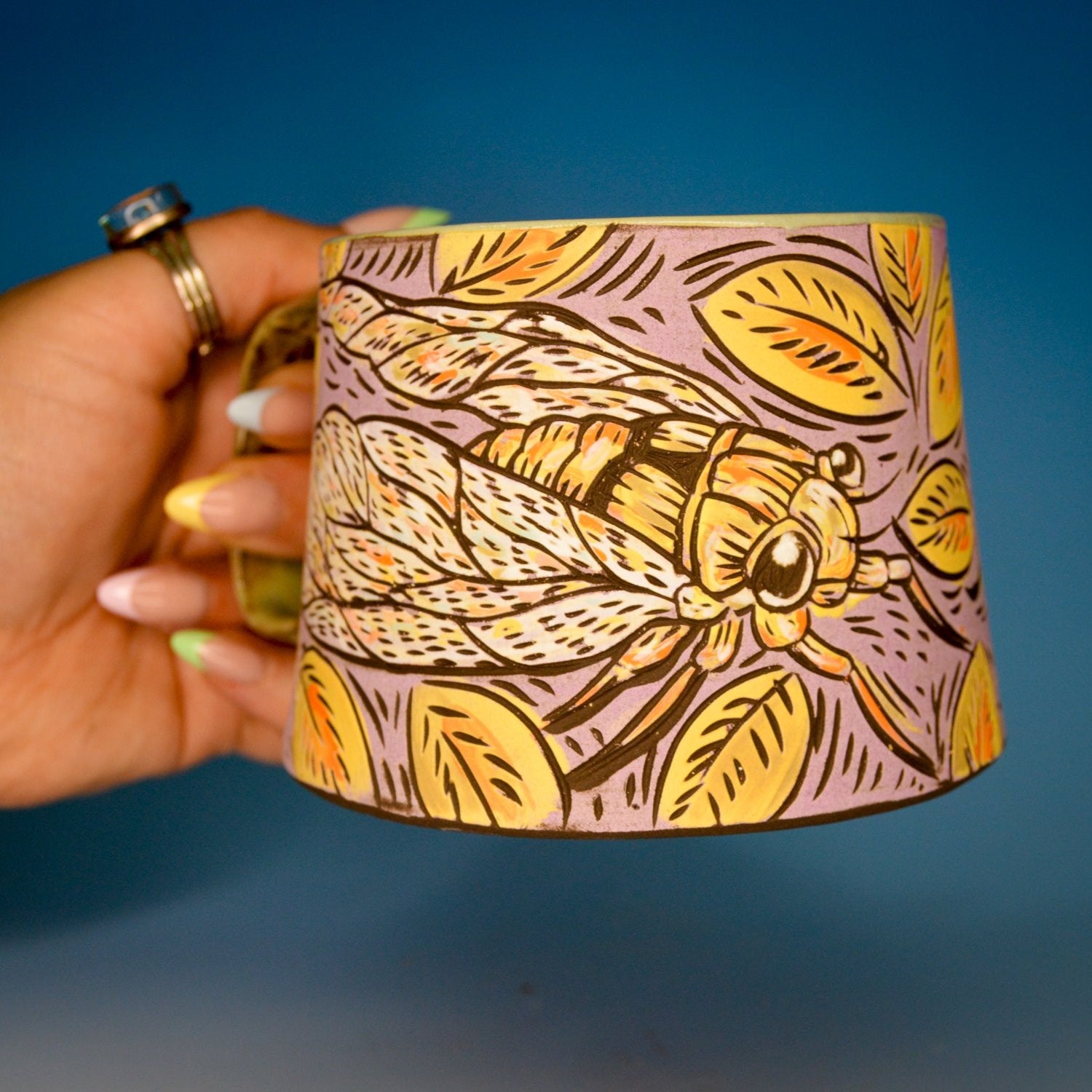 Handmade ceramic stoneware mug with a cute cicada bug design