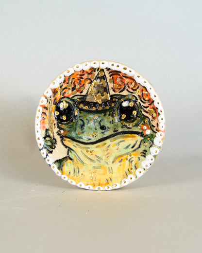 Ceramic coaster with wizard frog design