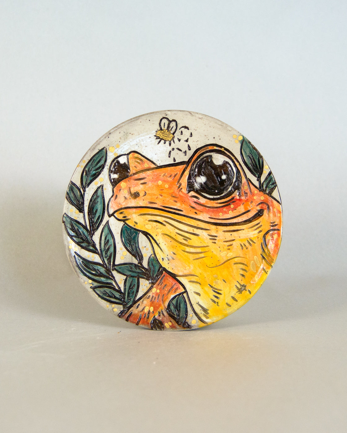Ceramic coaster with frog design