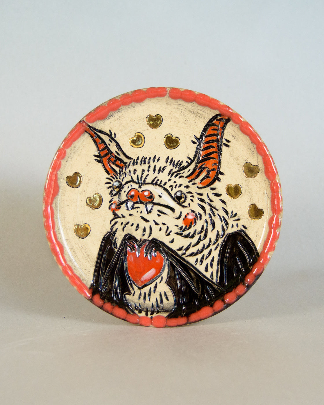 Ceramic coaster with bat and heart design