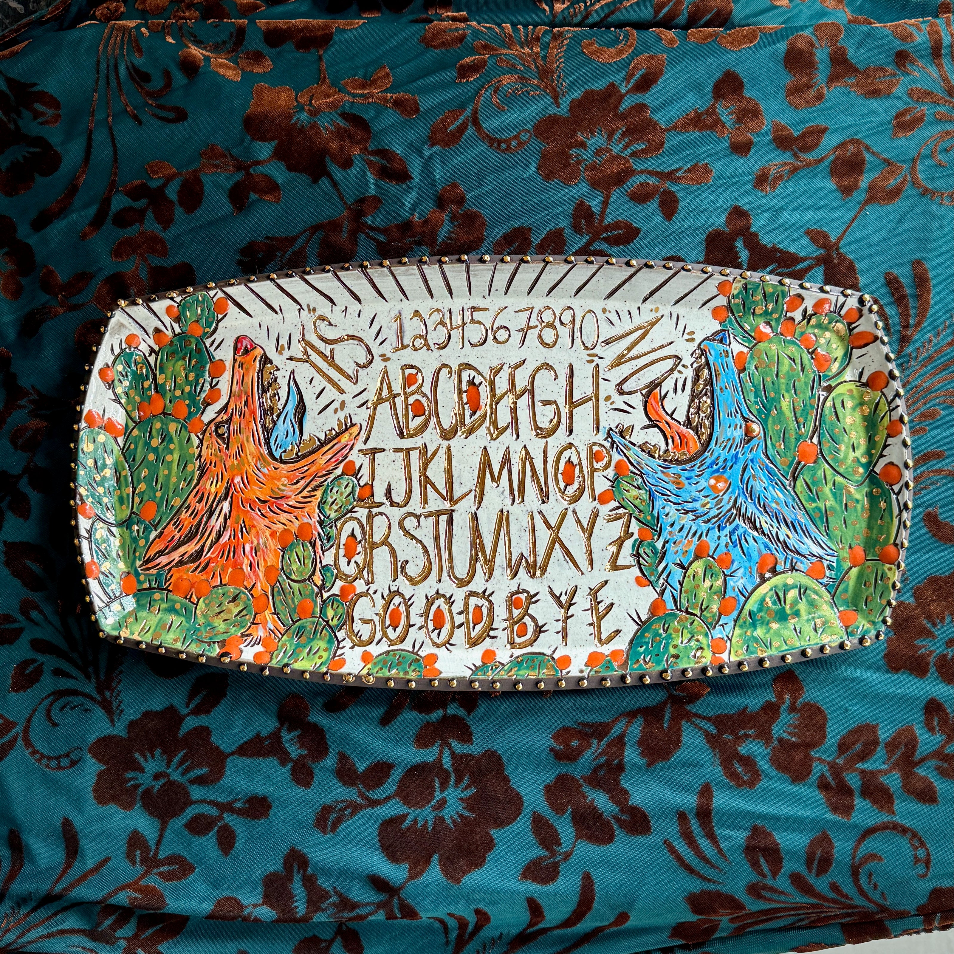 Handmade ceramic stoneware platter with a ouija board design of coyotes howling in cactus