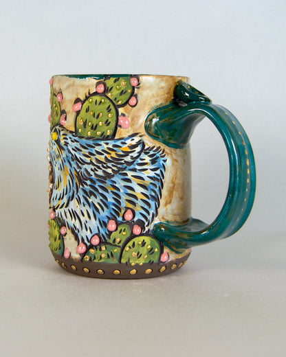 Ceramic mug with a colorful design of a coyote and cacti on a plain background