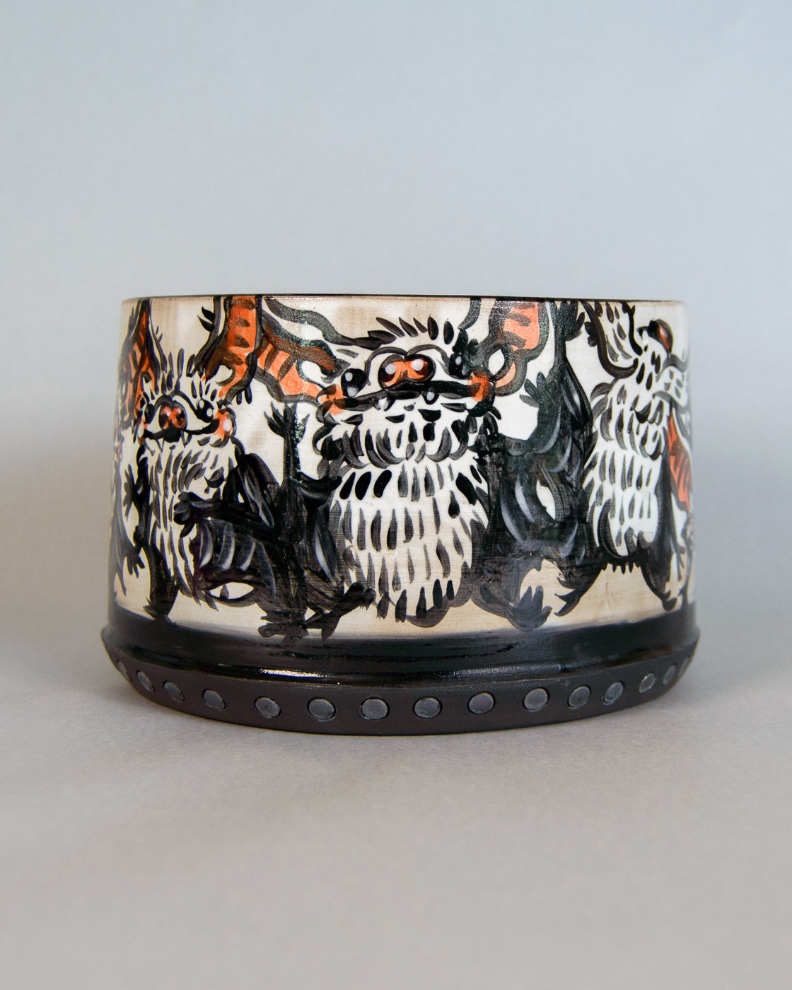 Ceramic planter with bat design on a light gray background