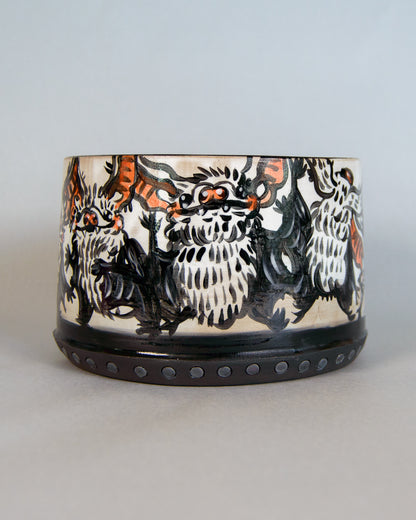 Ceramic planter with bat design on a light gray background