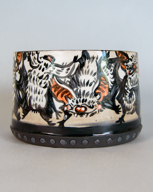 Ceramic planter with bat design on a plain background