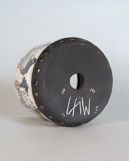 Cylindrical ceramic planter with decorative top and 'LAW' engraving on a light gray background