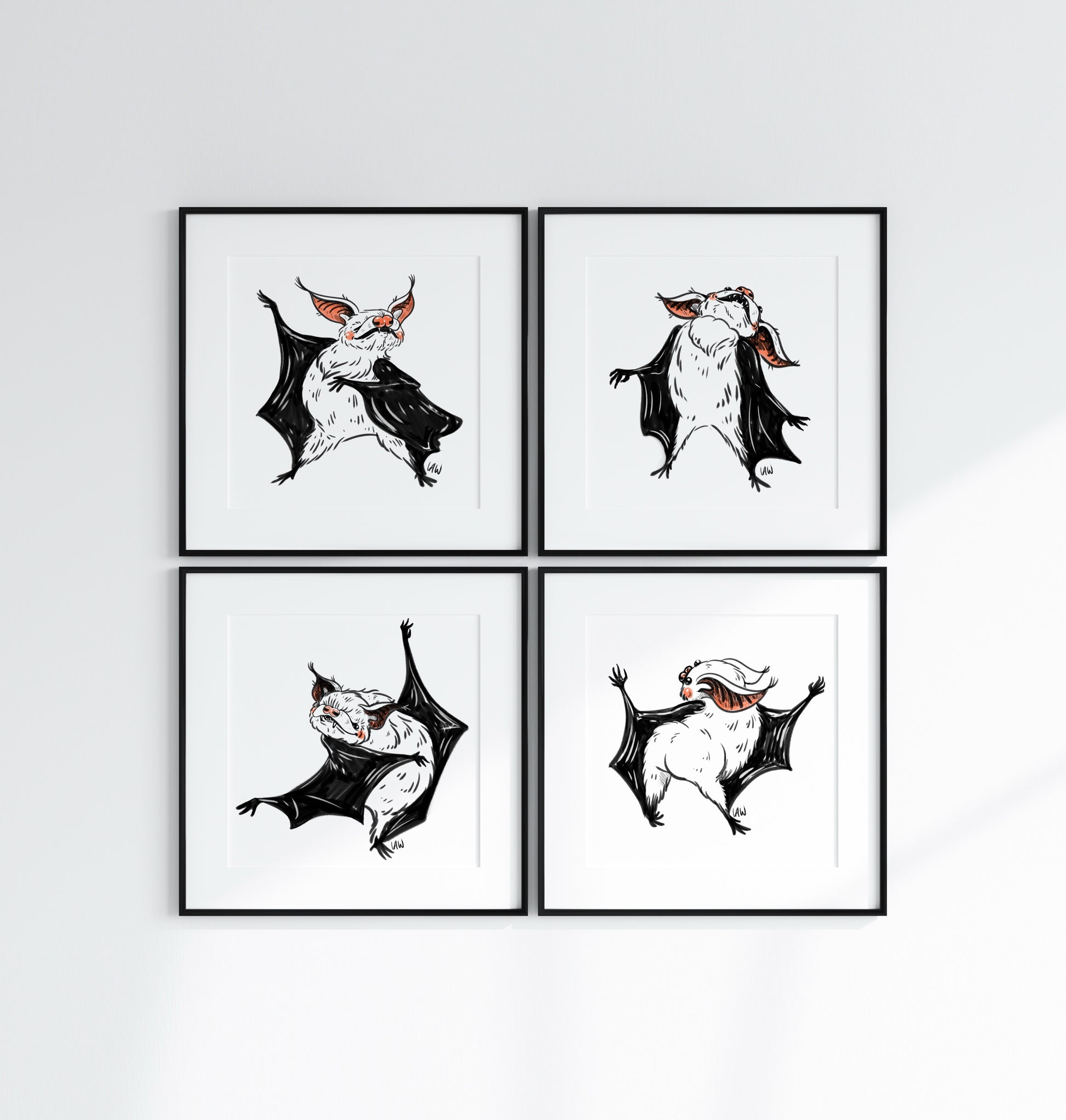 Four framed illustrations of bats on a white wall