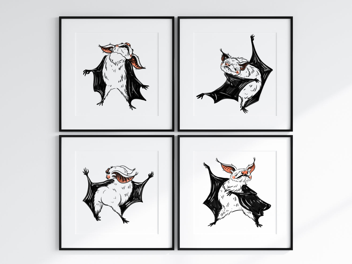Four framed illustrations of bats on a white wall.