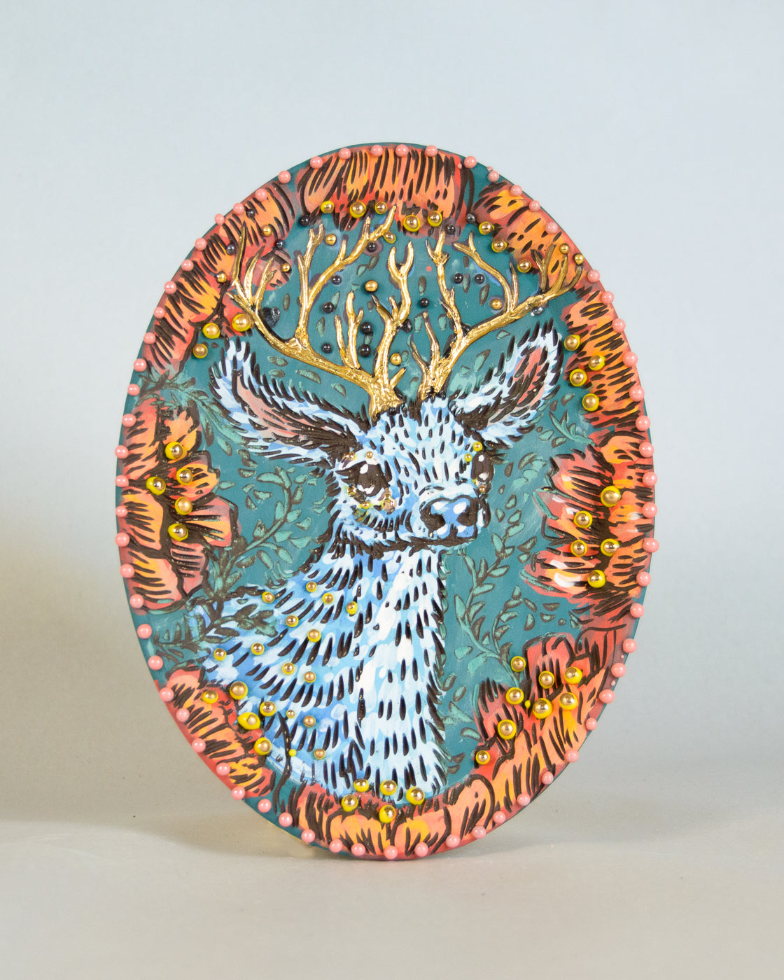 Decorative plate with a deer design on a plain background