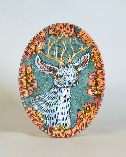Decorative plate with a deer design on a plain background