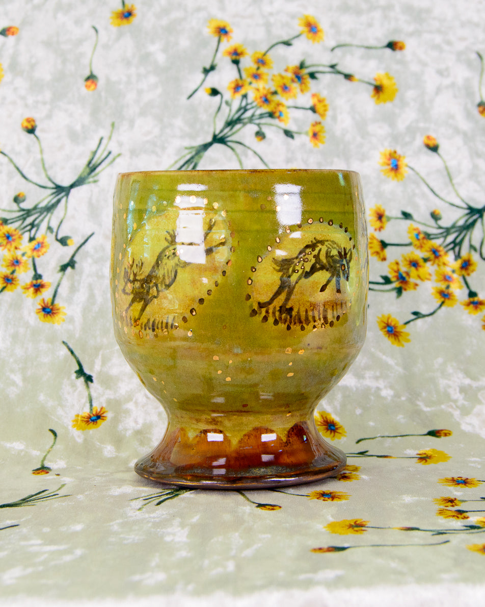 Decorative glass with a deer design on a floral background