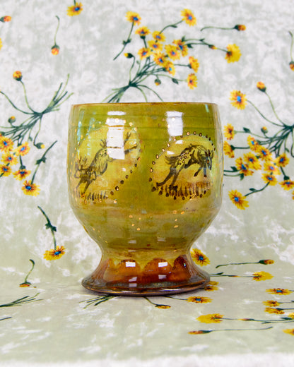 Decorative glass with a deer design on a floral background