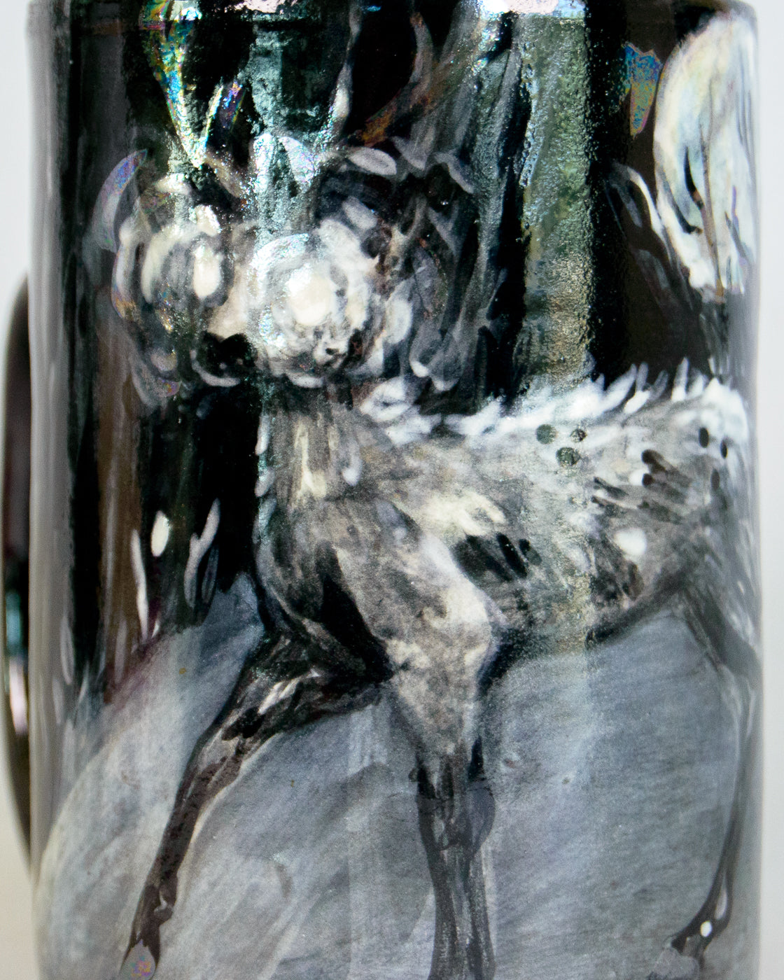 black and white ceramic mug piece with a deer design