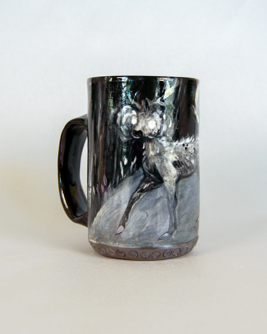 Black mug with a deer design on a white background