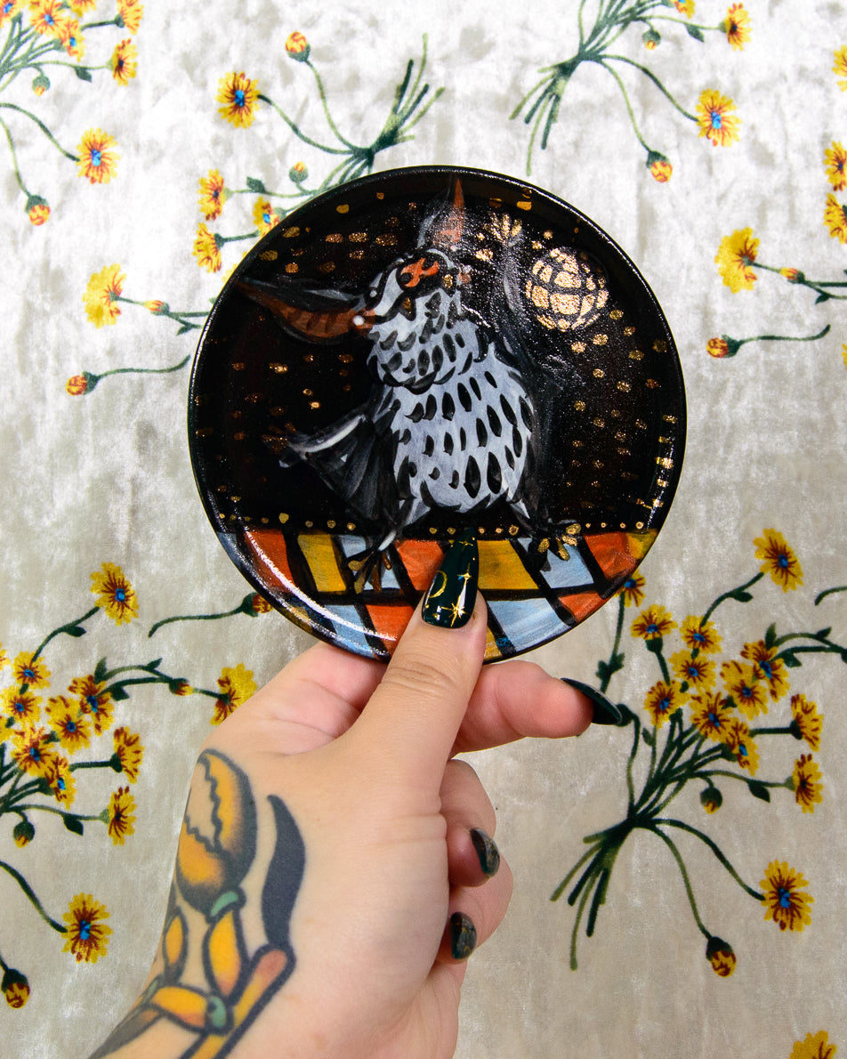 round ceramic coaster with a hand painted cartoon bat design and gold disco ball