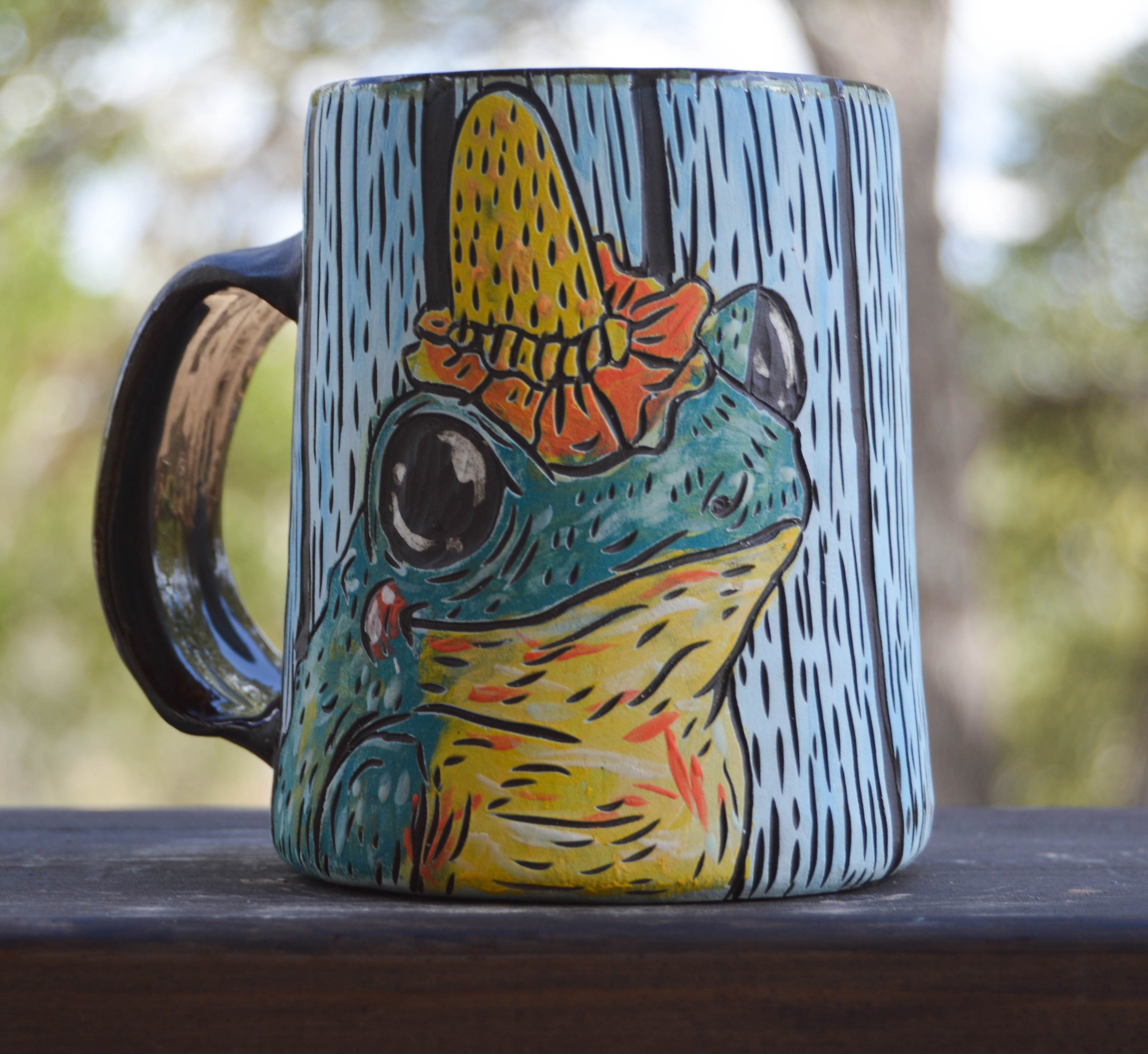 Handmade ceramic stoneware mug with frogs wearing flower hats design