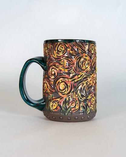 Ceramic mug with artistic forest fire design on a white background