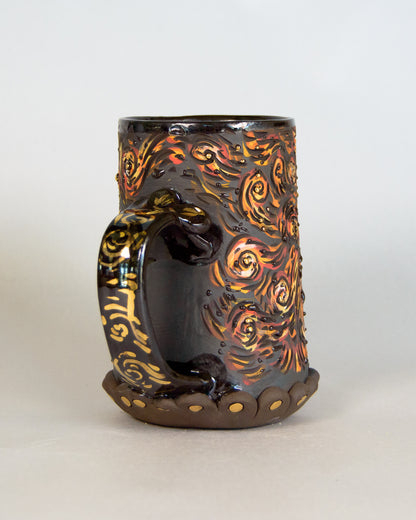 Decorative mug with artistic handle and patterns on a white background