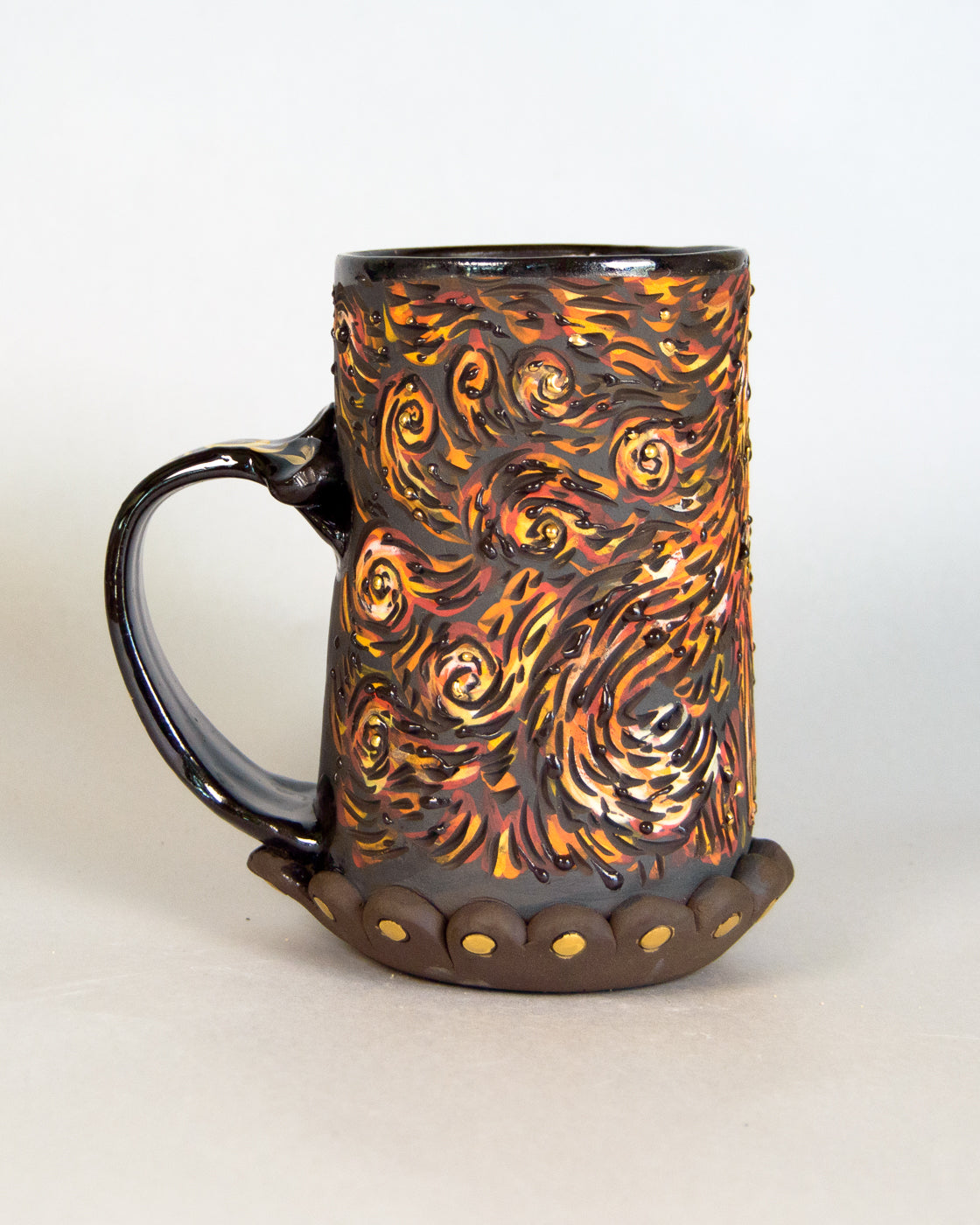 Ceramic mug with flame-like pattern on a white background