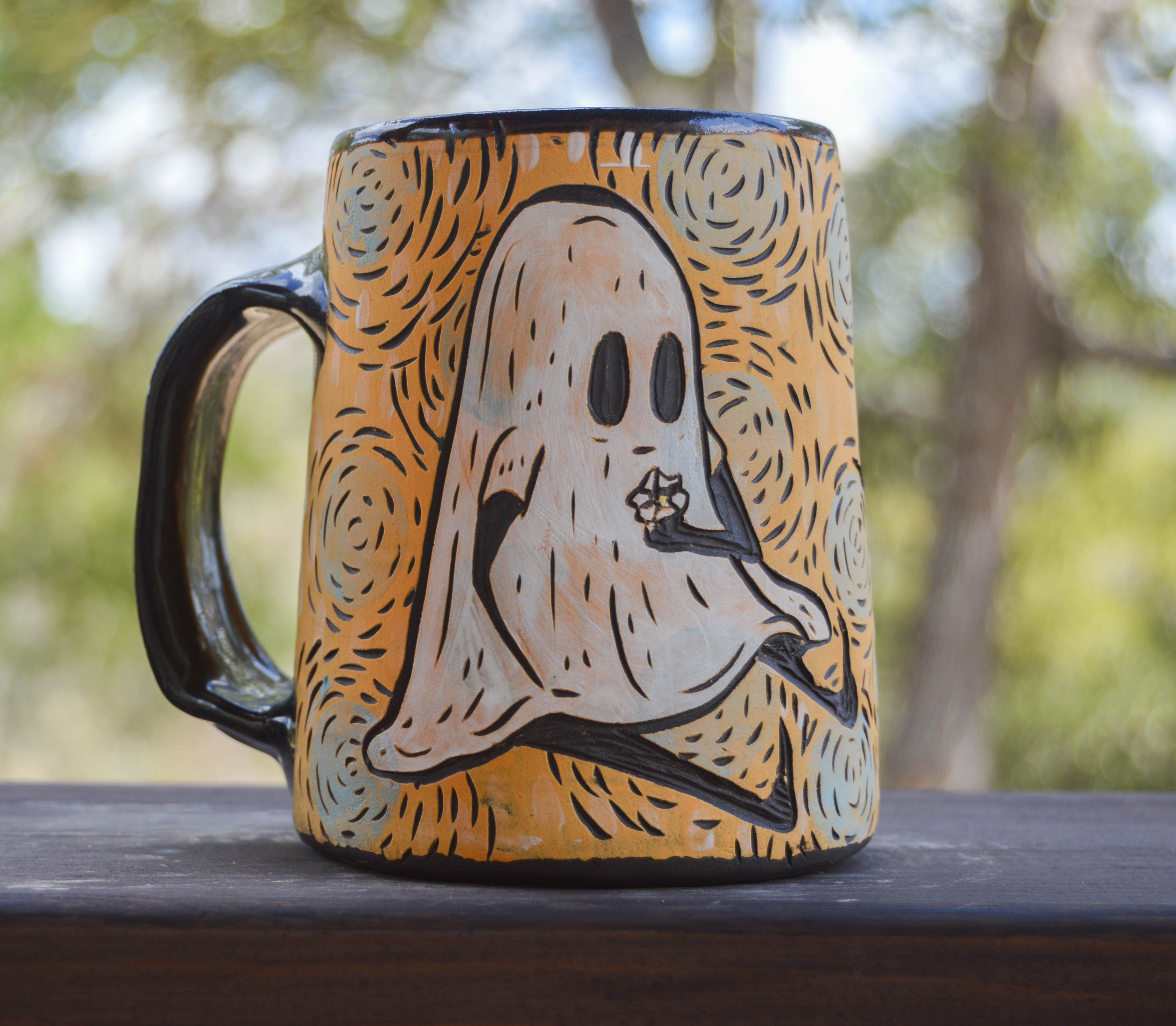Handmade ceramic stoneware mug with a ghost holding flowers design