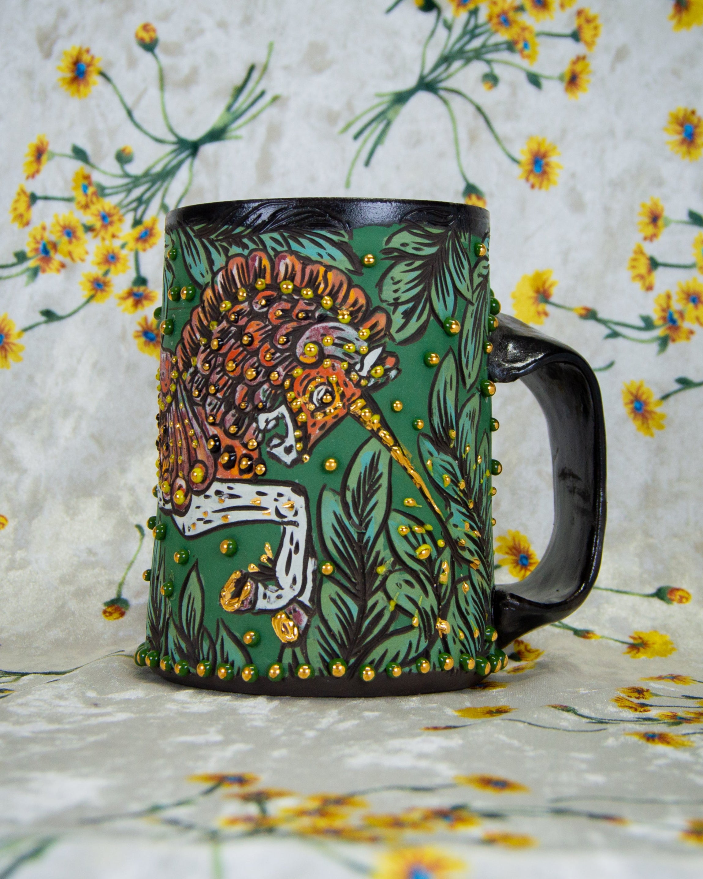 Handmade Ceramic mug with a stylized armored carousel unicorn design like a tapestry or illuminated manuscript