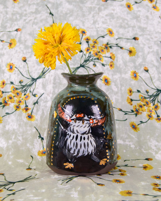 Decorative stoneware vase with a dancing bat design on a floral background