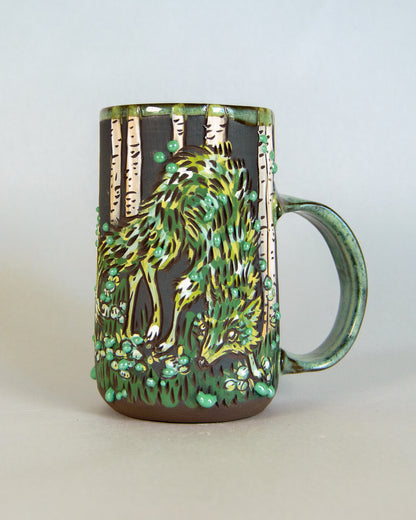 Mug with a nature-themed design featuring a green fox and trees on a plain background
