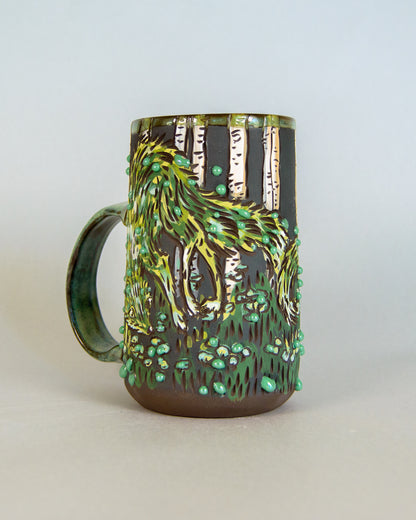 Ceramic mug with nature-themed design on a light gray background