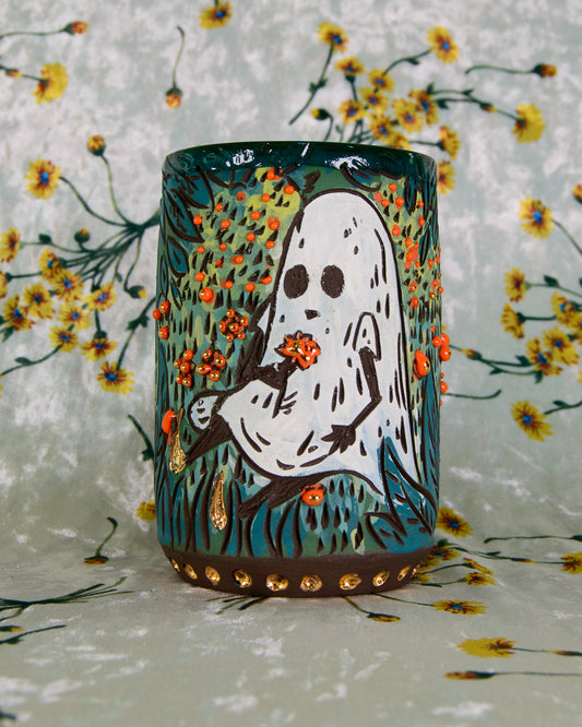 Ceramic mug with ghost design on a floral background