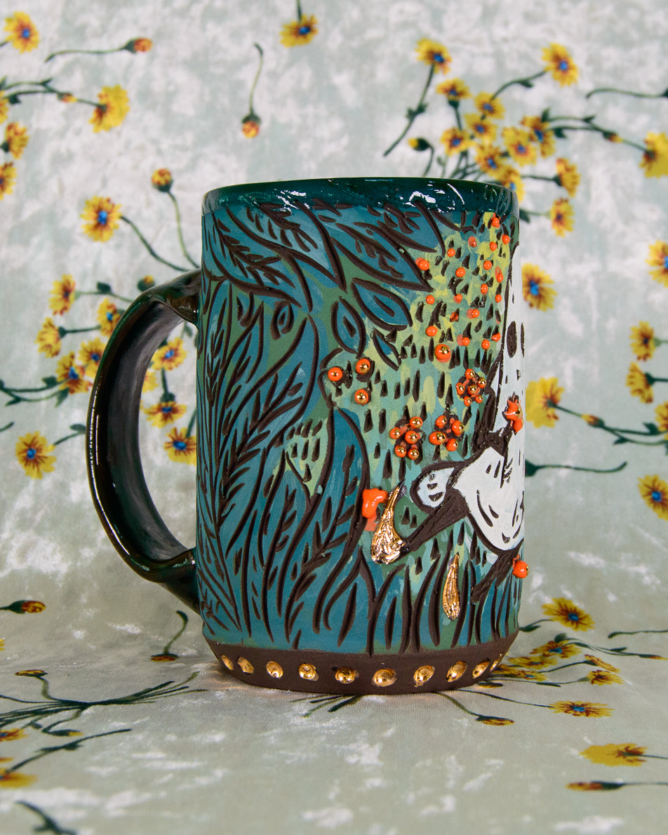 Decorative mug with green forest floral design on a floral background