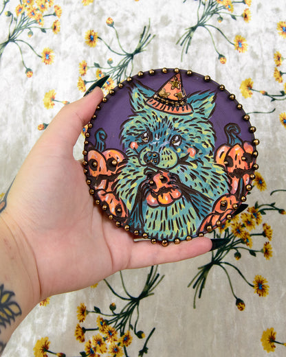 colorful ceramic coaster with a cute cartoon raccoon design and halloween pumpkins
