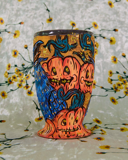 Ceramic cup with a colorful cartoon halloween pumpkin design