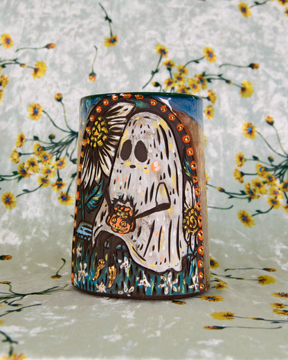 Ceramic mug with a ghost design on a floral background