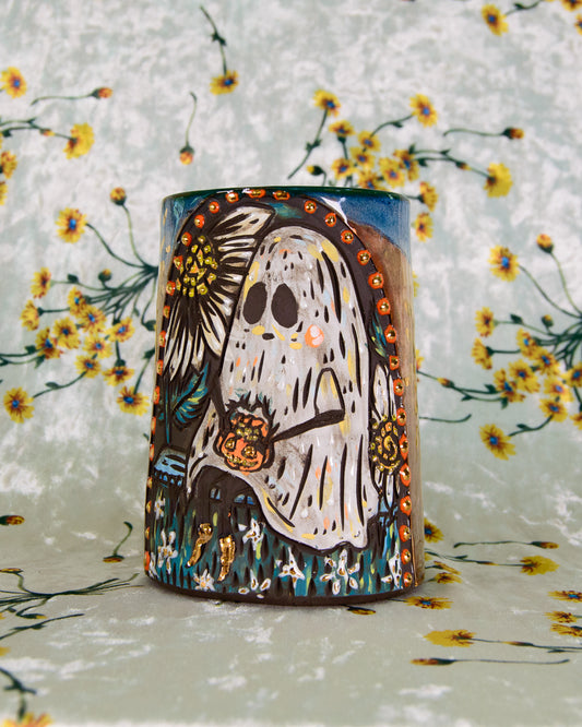 Ceramic mug with a ghost design on a floral background