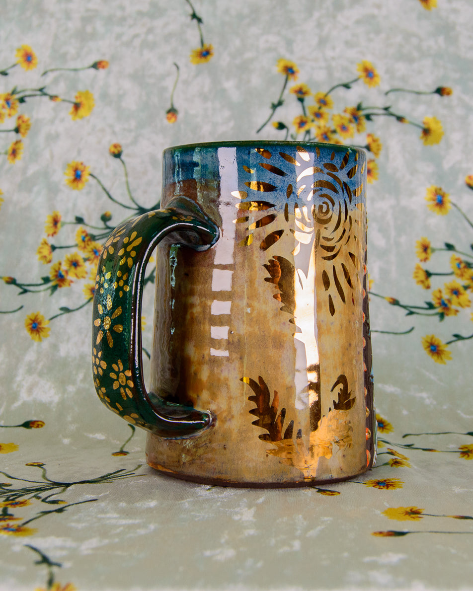 Ceramic mug with floral design on a floral-patterned background