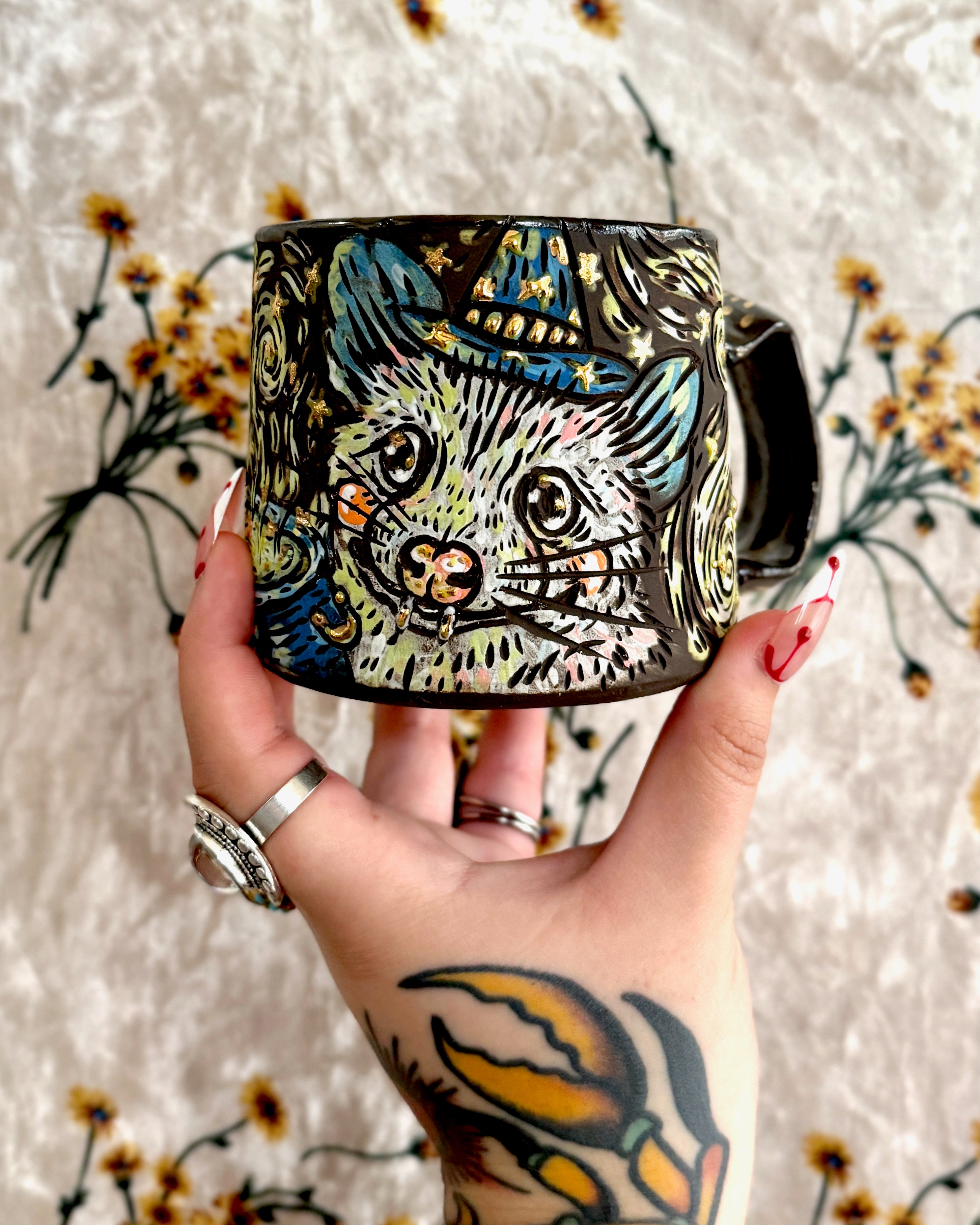 Handmade ceramic stoneware mug with a design of a witchy raccoon and possum making potions in a cauldron
