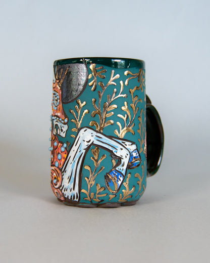 Decorative ceramic mug with artistic designs on a plain background