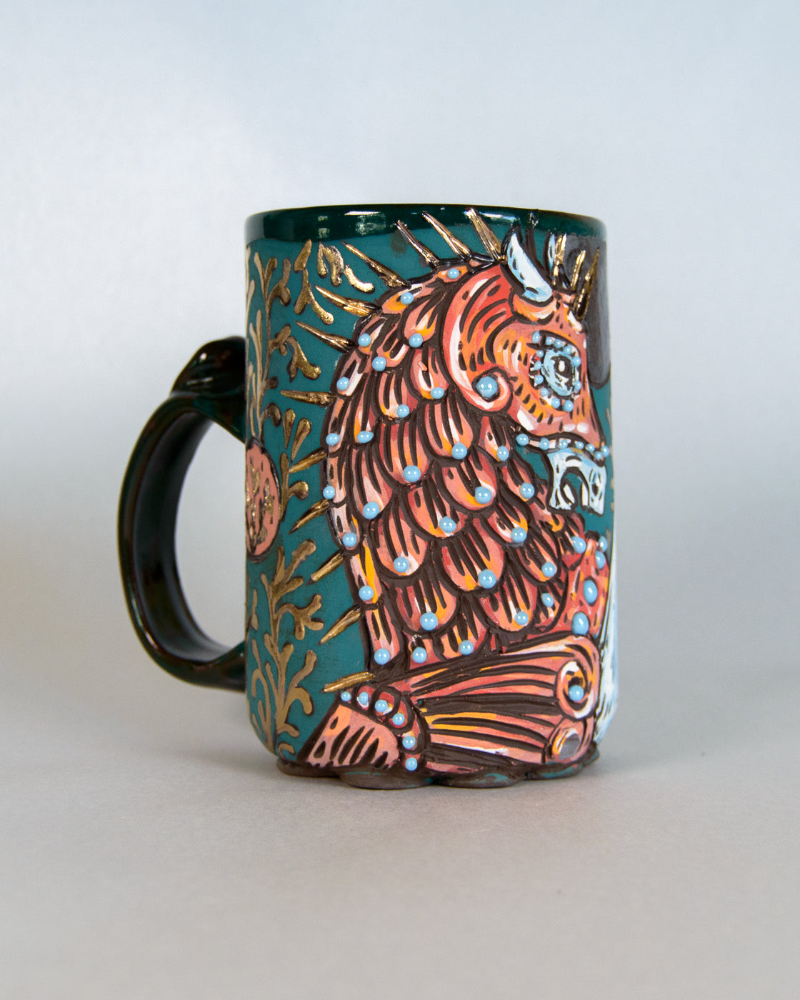 Colorful mug with a decorative unicorn design on a light gray background