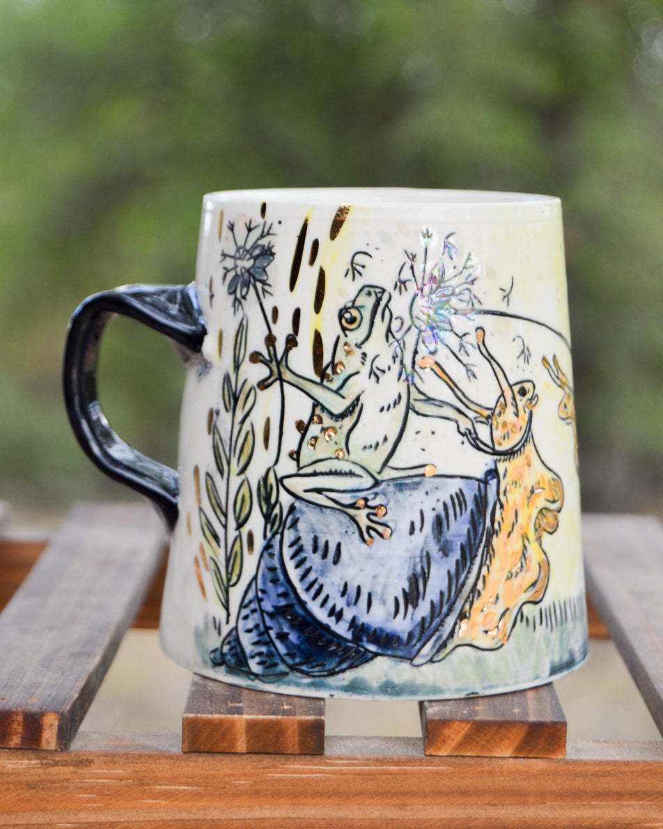 Handmade ceramic porcelain mug with frogs jousting with dandelions and riding snails design