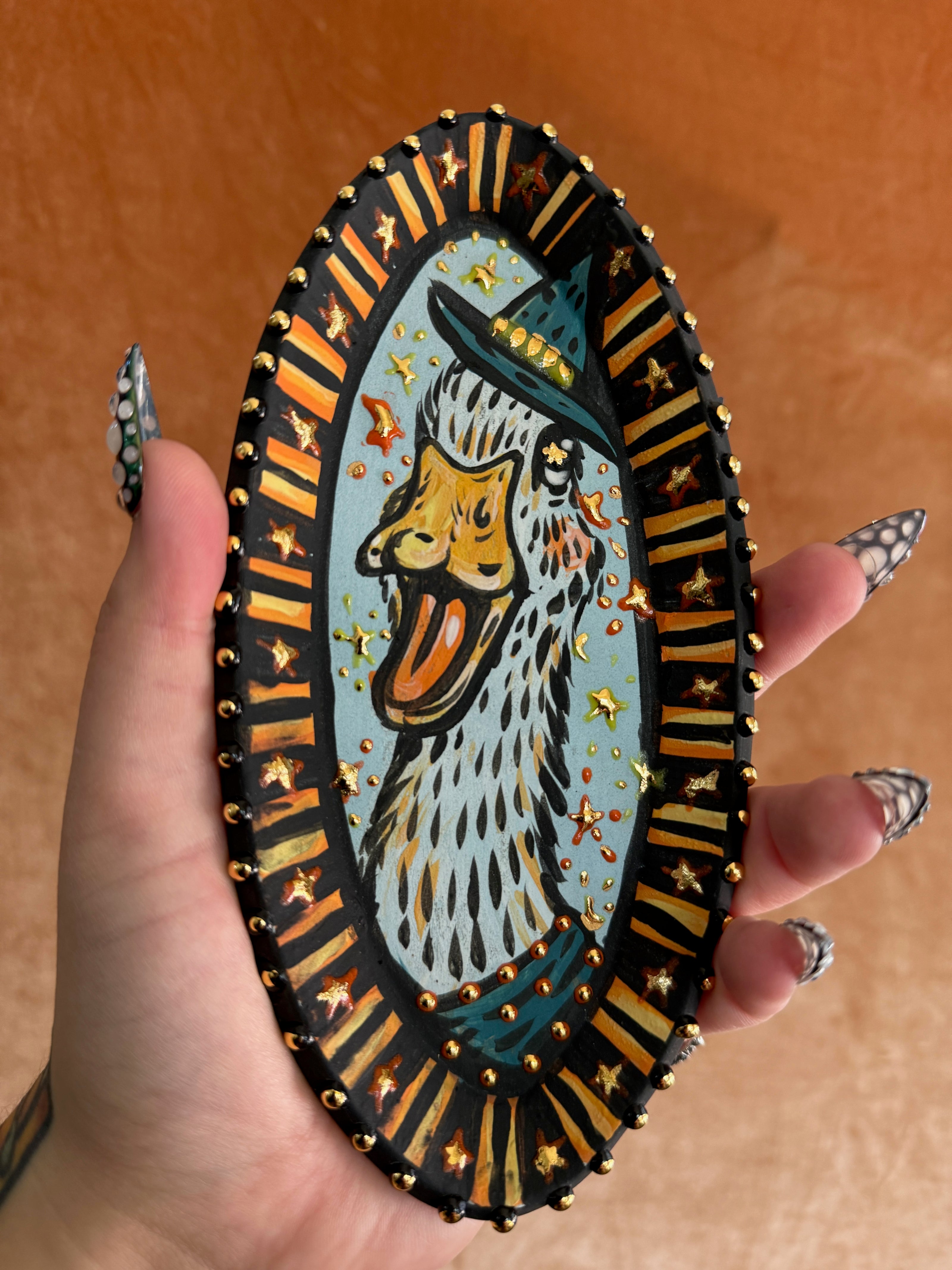 Handmade ceramic stoneware decorative plaque with a cute duck design, wizard hat, and golden stars