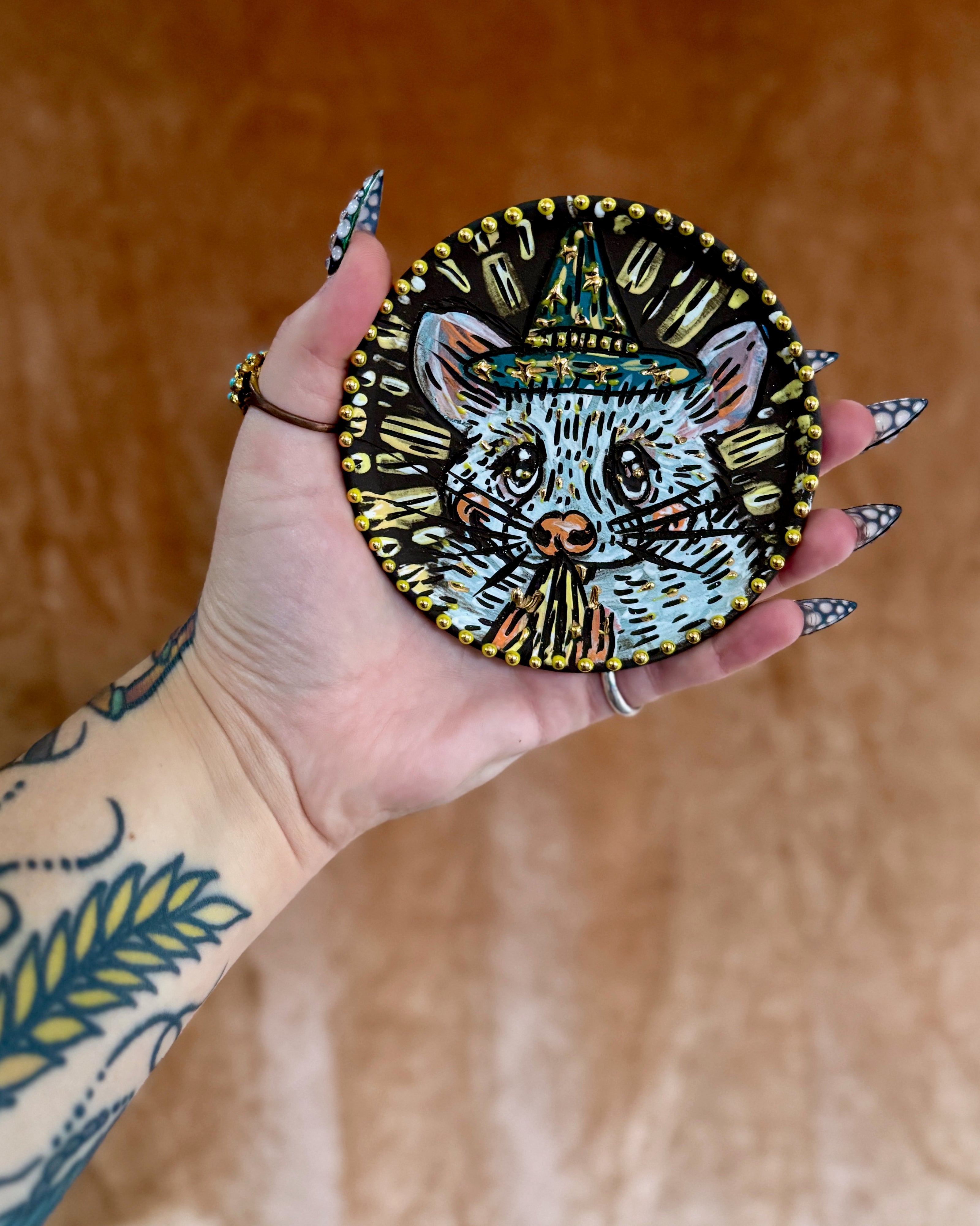 Handmade ceramic stoneware coaster with a cute magic mouse holding a seed design