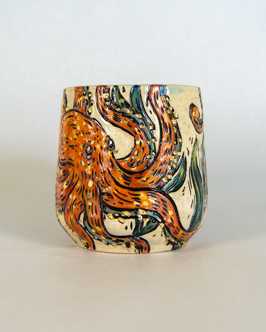 Ceramic mug with a colorful octopus design on a light gray background