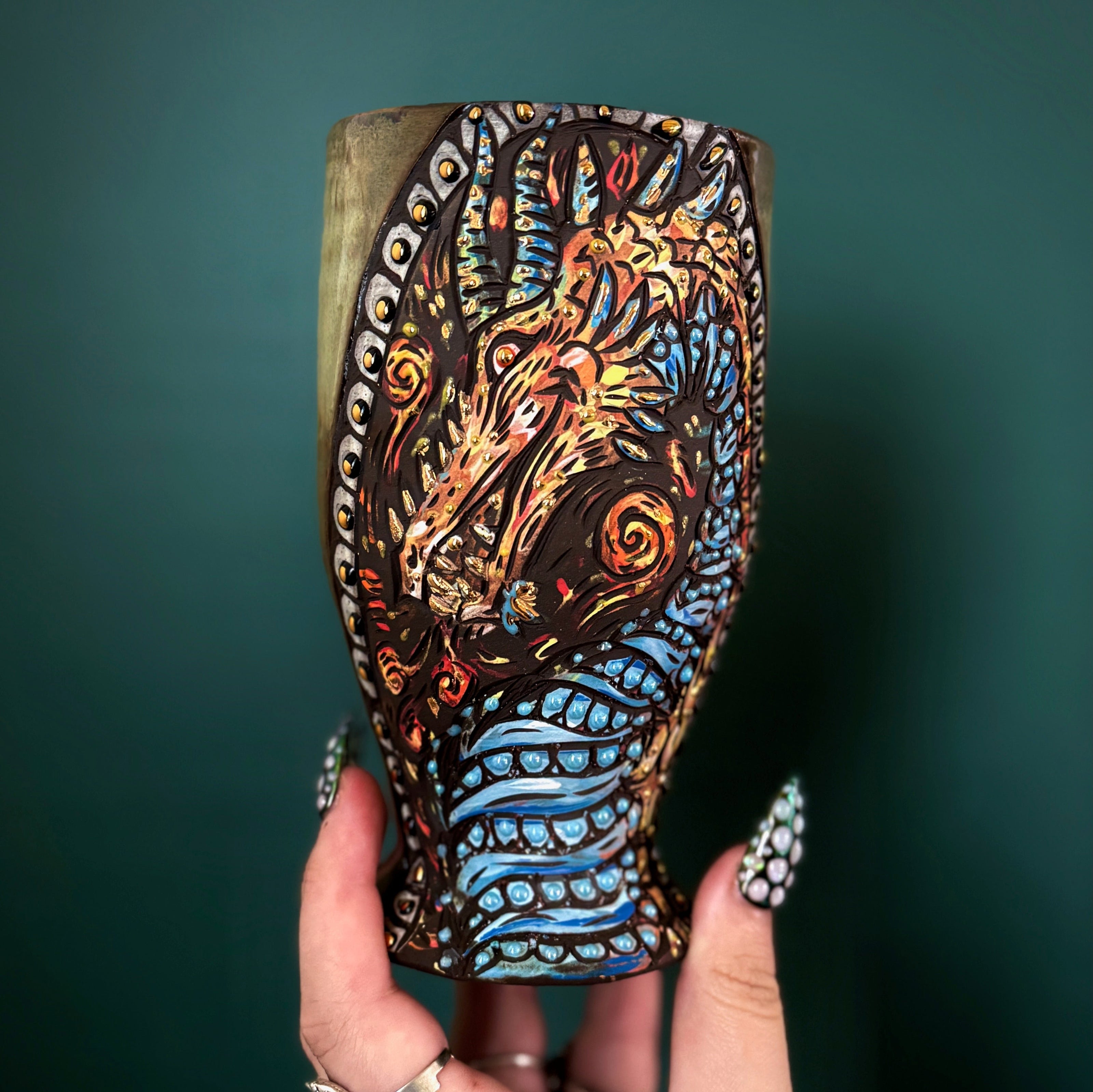 Handmade ceramic cup with a stylized cartoon dragon design